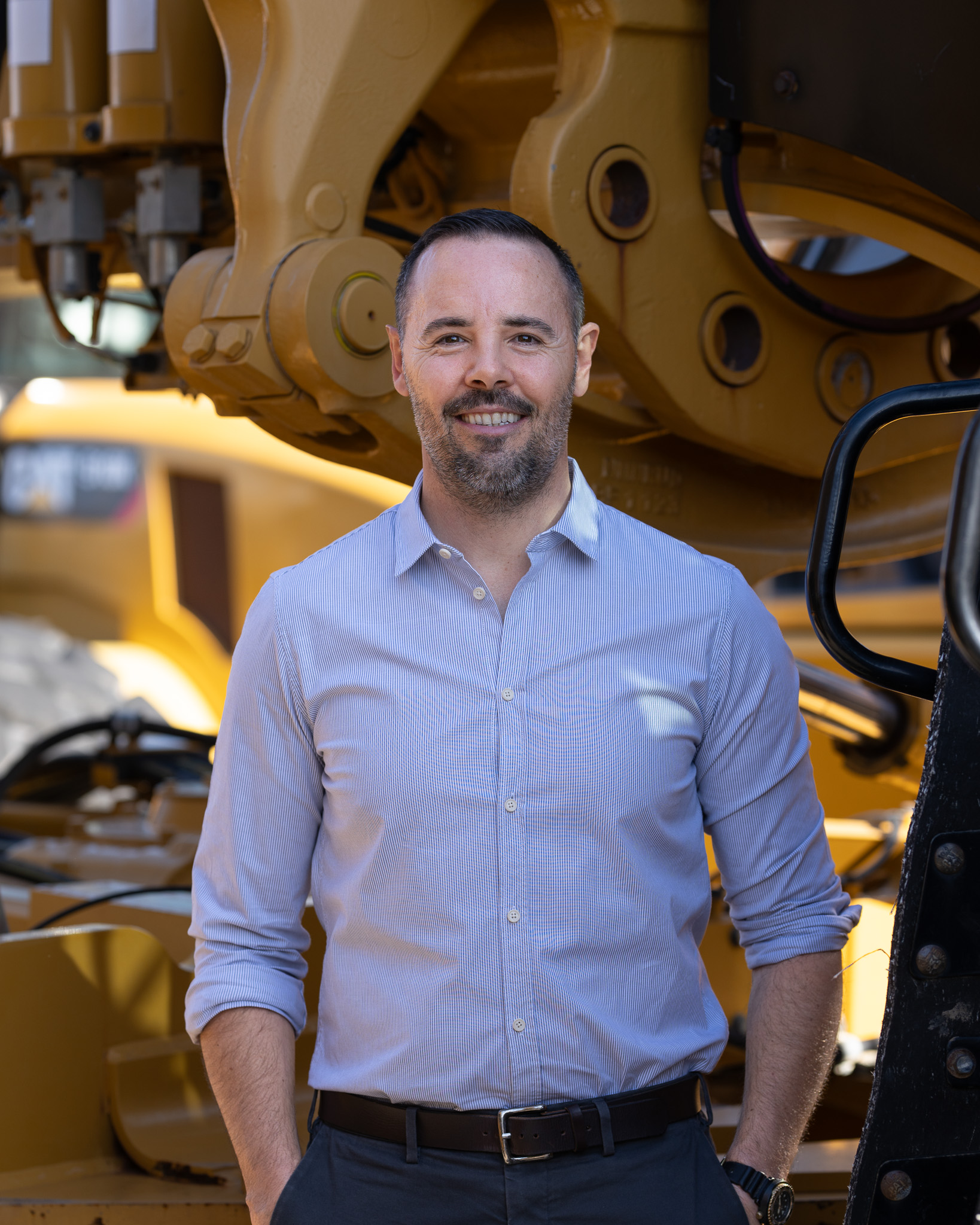 Daniel Salajan beside heavy equipment