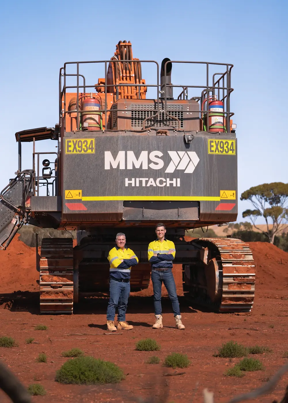 James and the MMS team in front of a Hitachi mining excavator