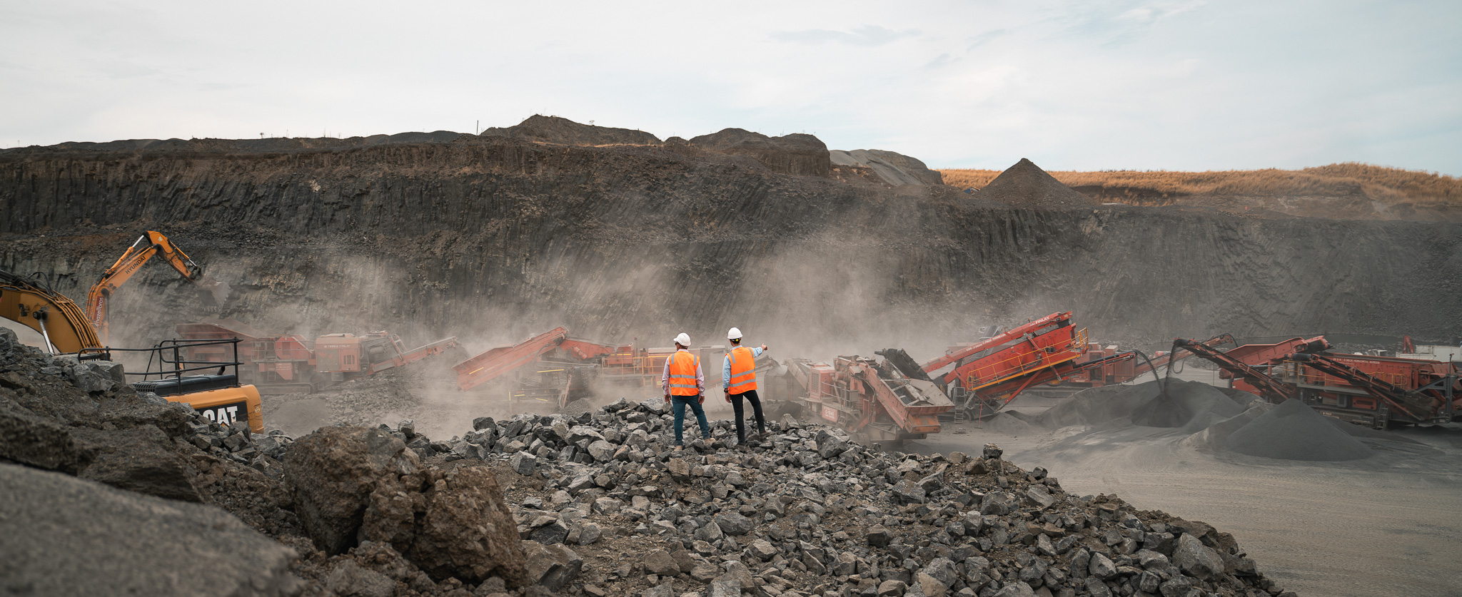 Mining and quarry team overlooking crusher and screener equipment