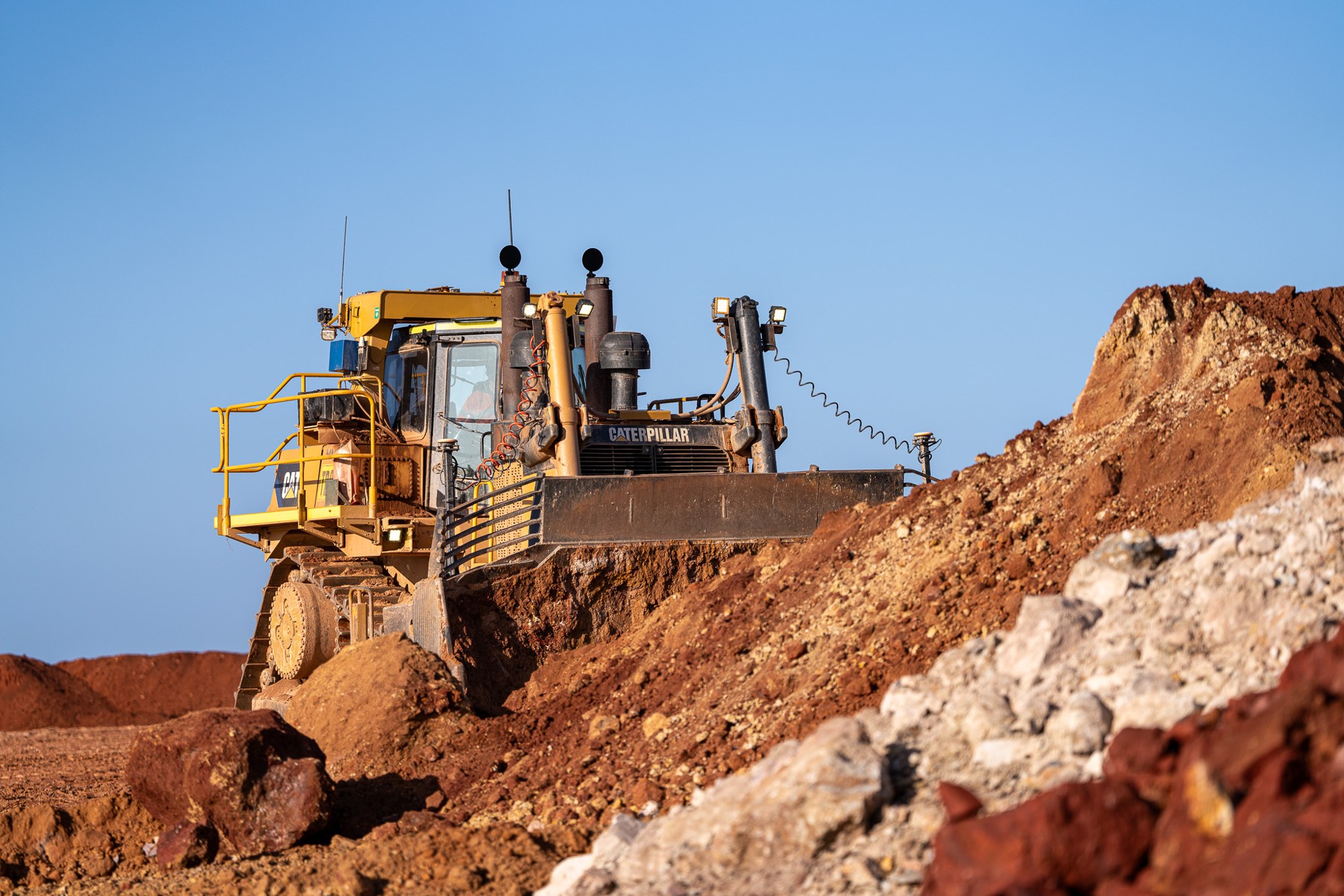 equipment working through earth at a mine site