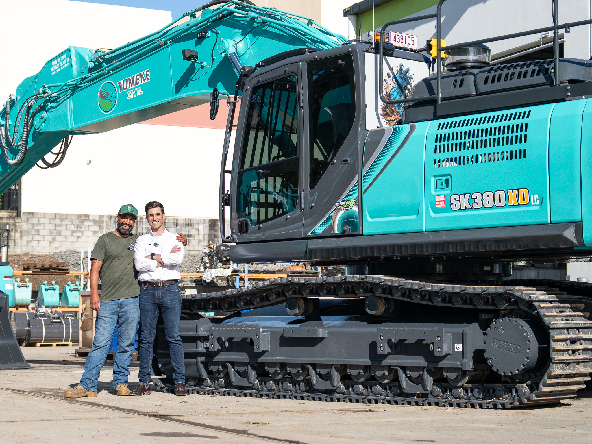 Tony Rore and James Allan beside a Tumeke Civil Kobelco excavator