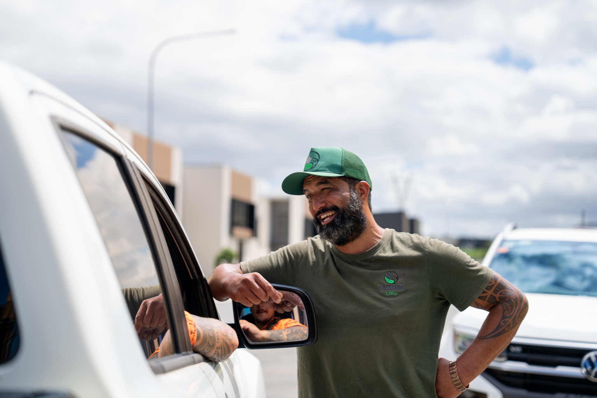 Tony Rore speaking beside a vehicle